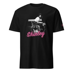 Shirley Muldowney sits on her dragster with bright pink cursive text that says "Shirley"